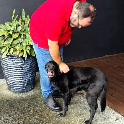 Philippe with a happy dog in a Gold Coast backyard
